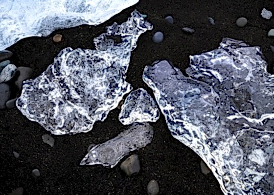 Clear ice formations on black sand at Diamond Beach, Iceland