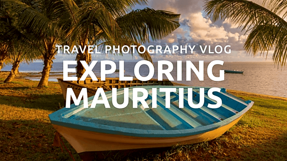 Blue boat on grassy shore with palm trees, Mauritius